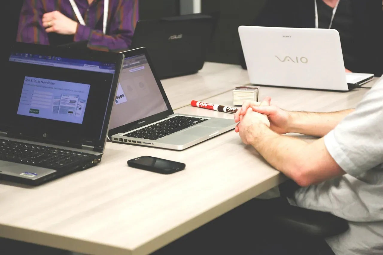 Colleagues in a business meeting with laptops on the table