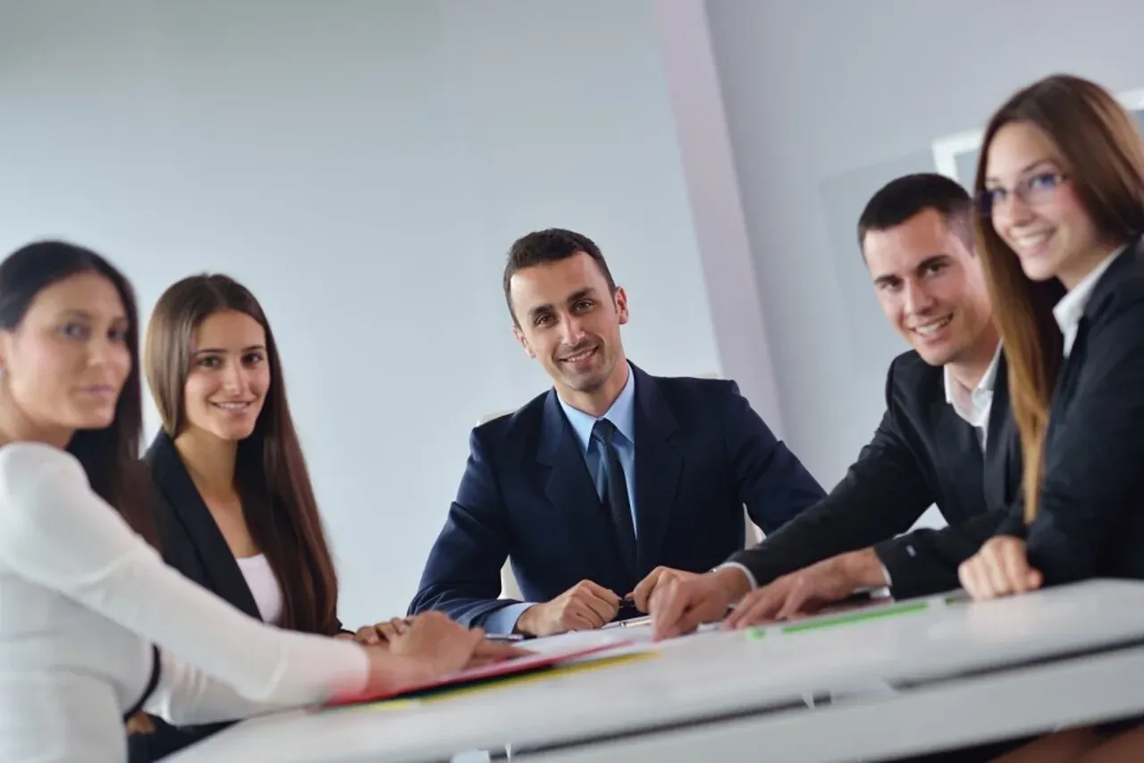 Business team smiling around a conference table