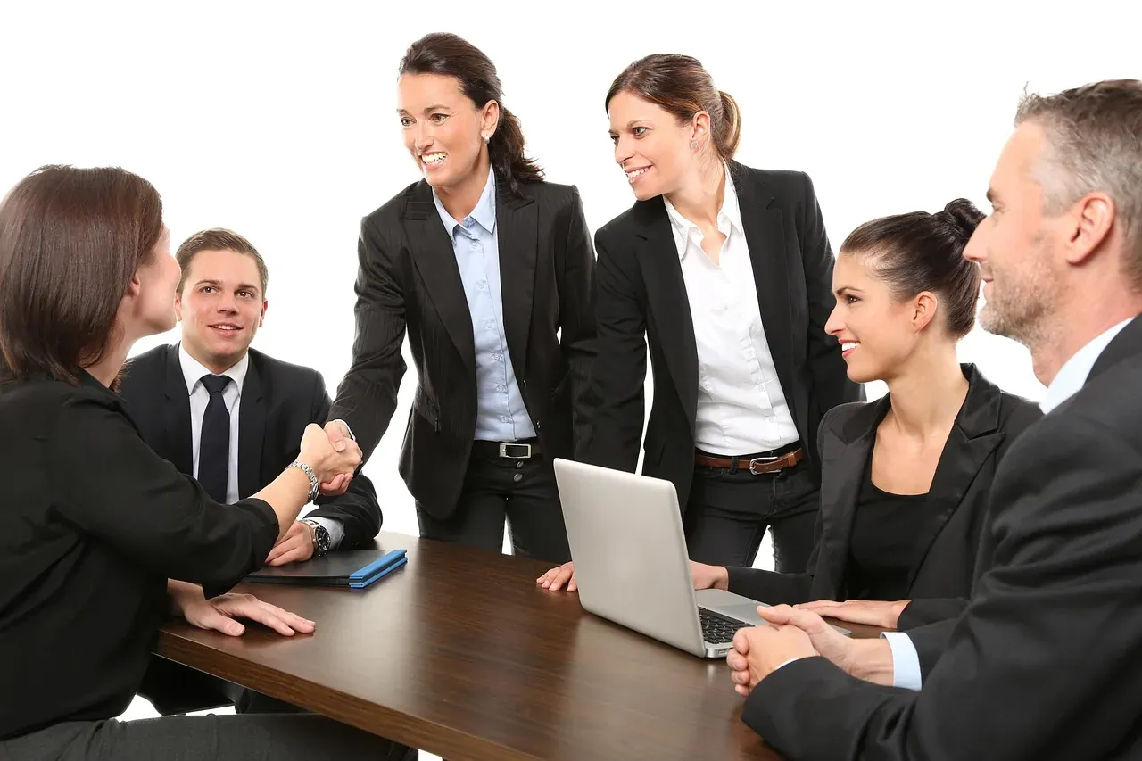 Business team greeting each other with a handshake at a meeting