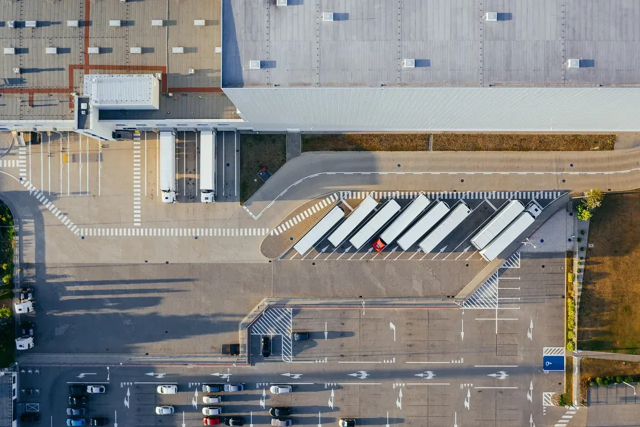 Aerial view of a distribution centre with trucks parked at its loading bays