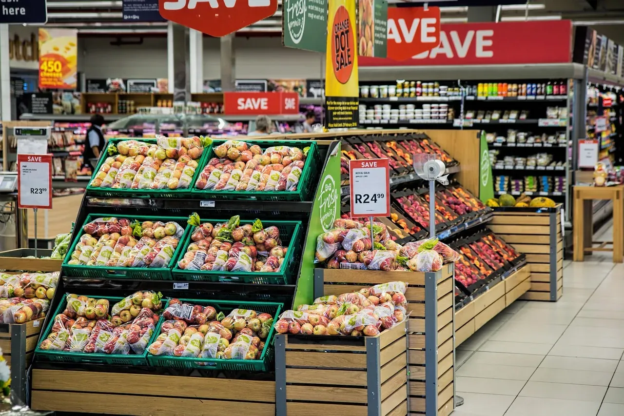 Supermarket produce aisle with sale signs