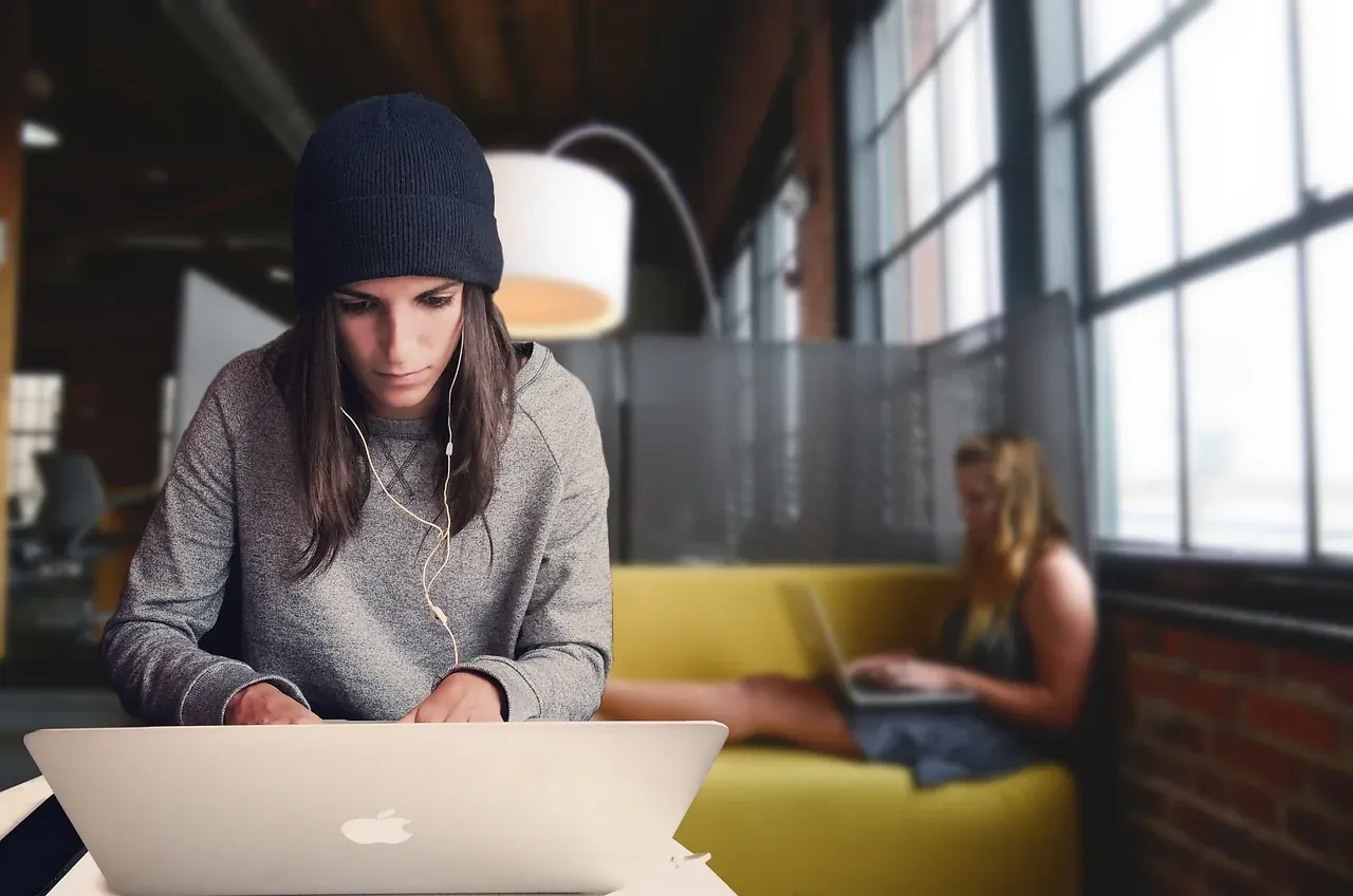 Woman working on a laptop in a coworking space